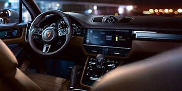 Couple Driving Porsche Cayenne in Palm Springs CA